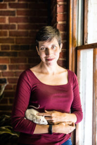 Author Bethany Brookshire lovingly pets a rat