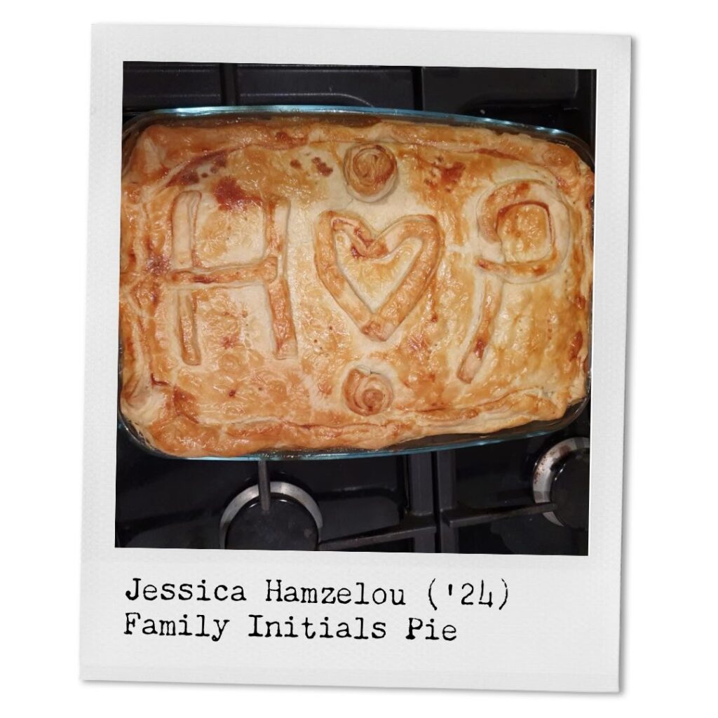Jessica Hamzelou ('24) Family Initials Pie
A rectangular glass pan sits on top of a stovetop filled with pie fresh out of the oven. The golden crust highlights the shape of an H, a heart, and a P made out of dough on top of the pie. 