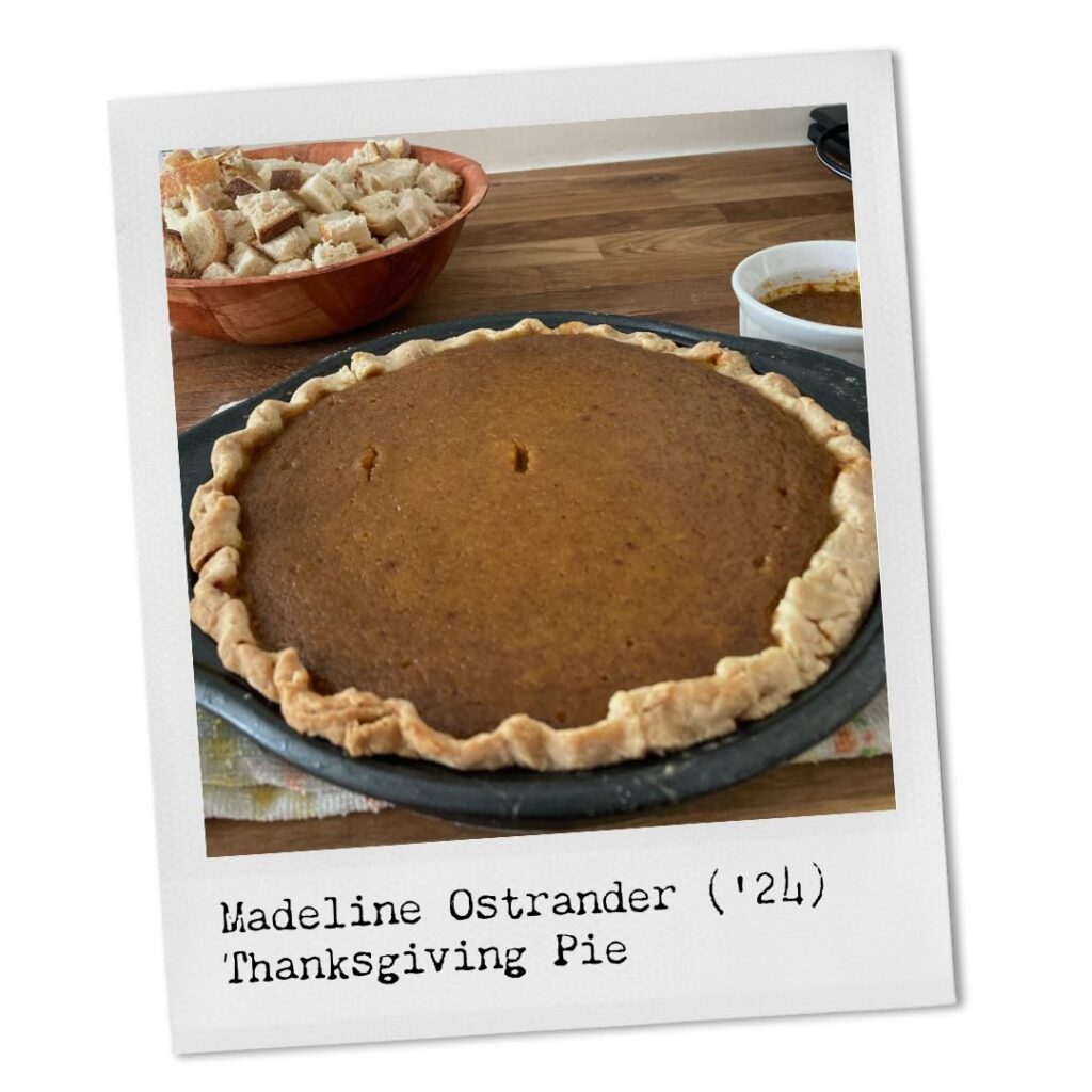 Madeline Ostrander ('24). Thanksgiving Pie. A pumpkin pie sits on a butcher block counter top next to a bowl of cubed bread, presumably the bread waiting to be added to stuffing in another thanksgiving dish that will accompany the pie. 