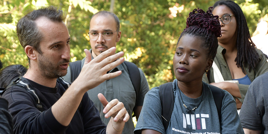 KSJ fellow asks a question during a nature walk while other fellows listen